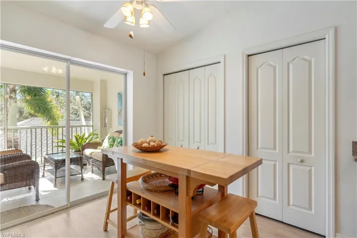 Dining space featuring light hardwood / wood-style floors, vaulted ceiling, and ceiling fan