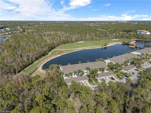 Birds eye view of property with a water view