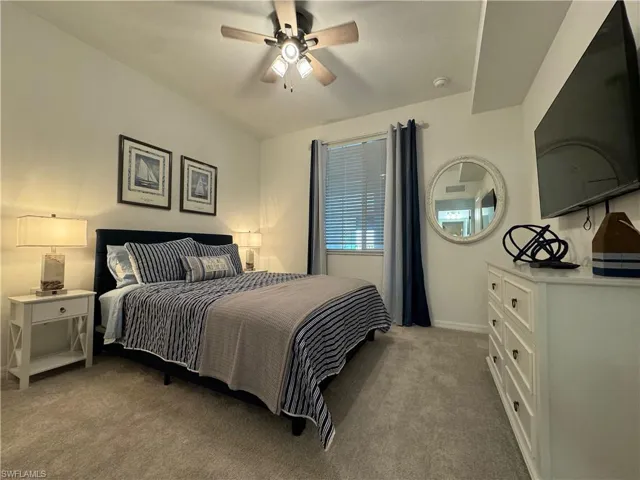 Carpeted bedroom with ceiling fan