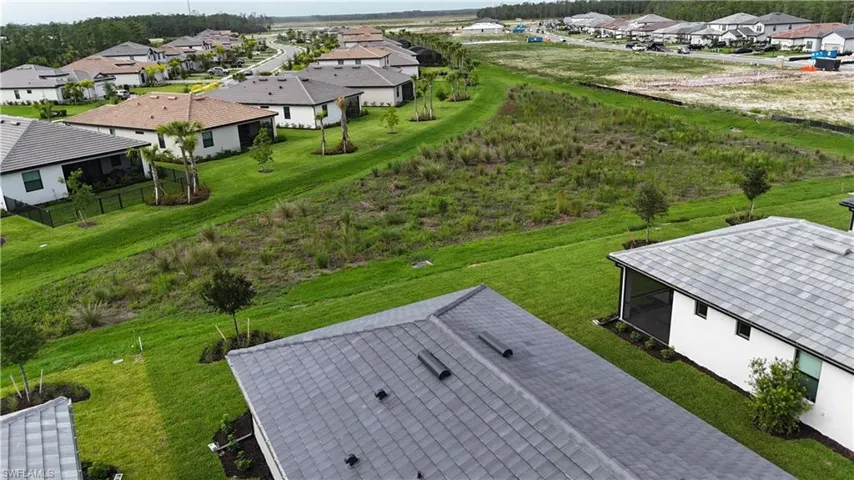 Contemporary residential neighborhood featuring single-story homes with shingle roofs and manicured lawns