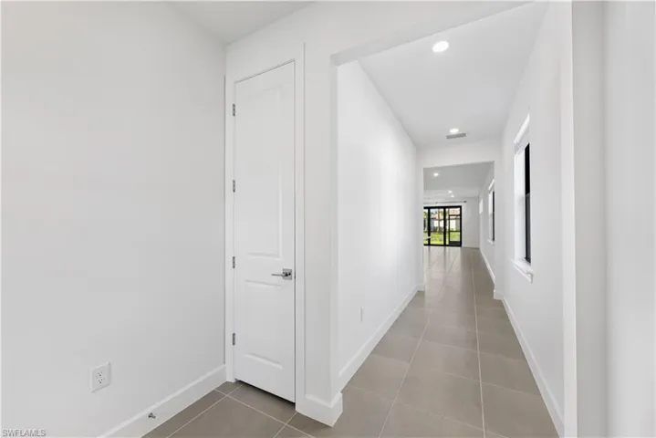 Entryway featuring neutral wall tones, recessed lighting, and rectangular tile flooring