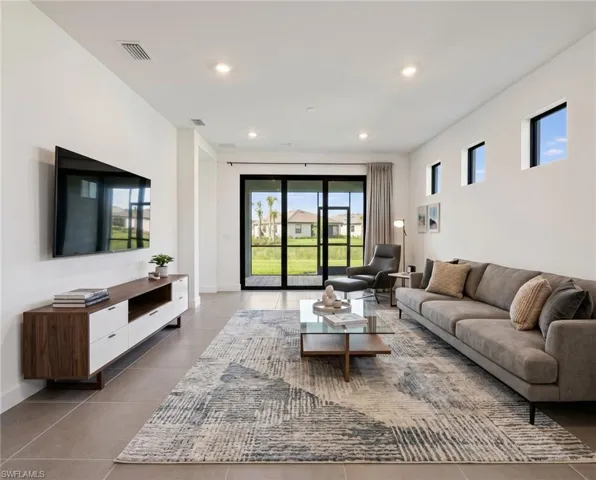 *Virtually Staged*Spacious living area featuring large format tile flooring and recessed lighting