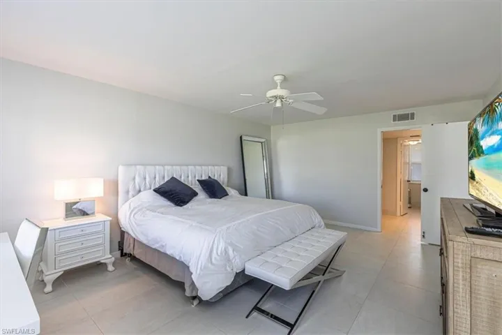 Bedroom with a ceiling fan and baseboards
