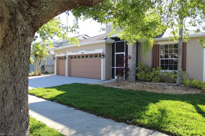 View of front of house featuring a garage and a front yard