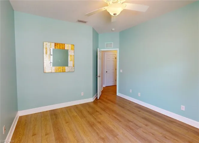 Spare room featuring ceiling fan and hardwood / wood-style floors