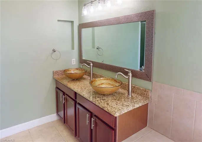 Bathroom featuring tile floors and vanity