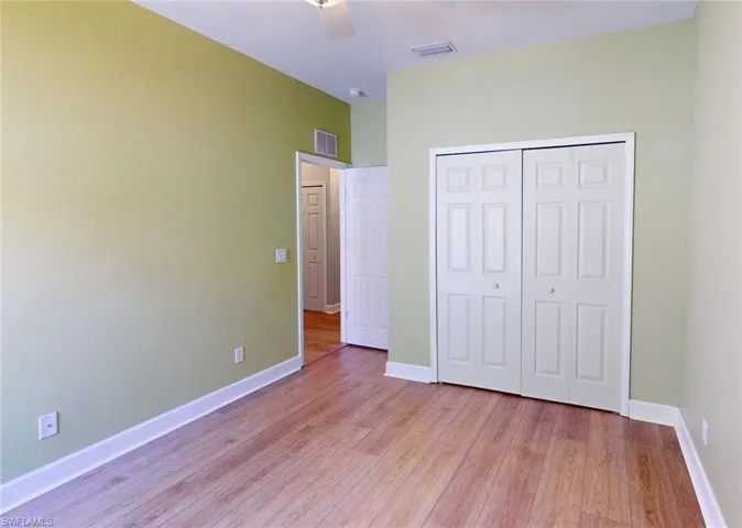 Unfurnished bedroom featuring ceiling fan, a closet, and light hardwood / wood-style floors