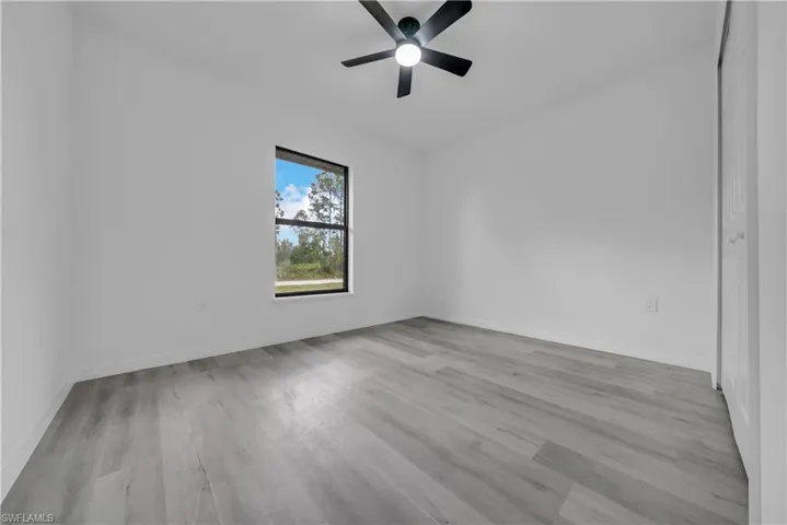 Empty room featuring light wood-style flooring and ceiling fan