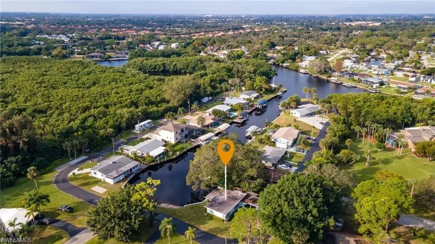 Aerial view of residential area featuring a nearby body of water