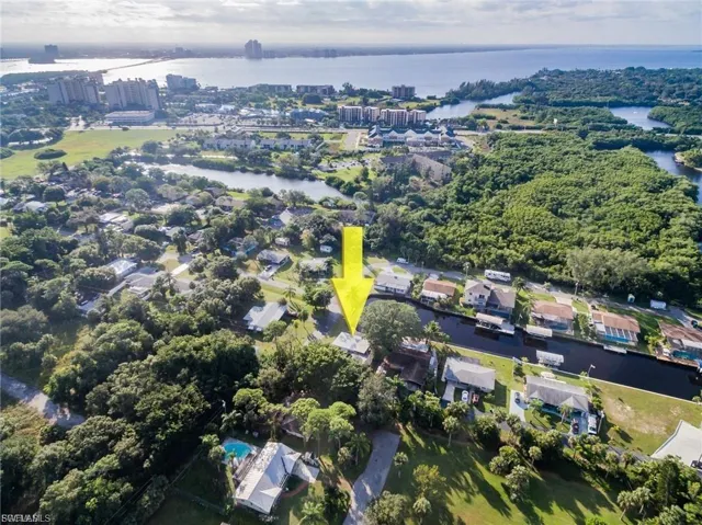 Aerial overview of property's location with a large body of water and nearby suburban area