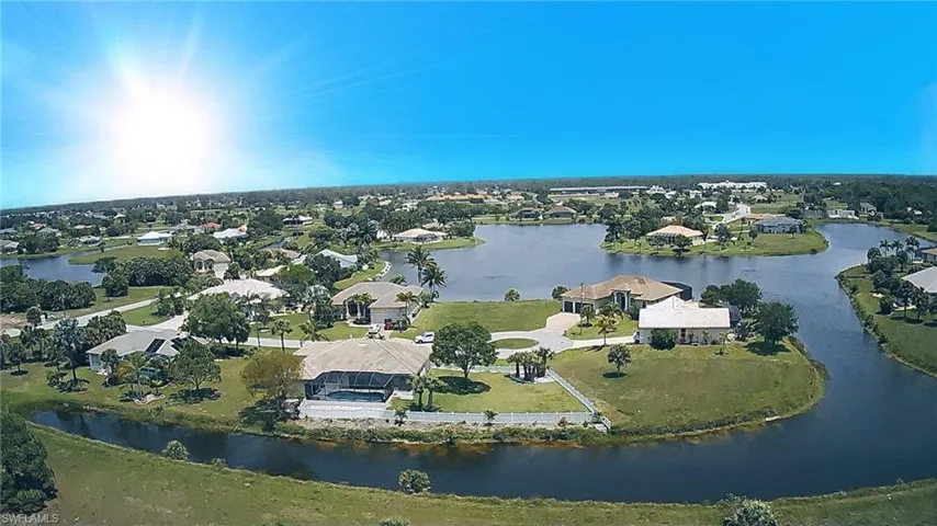Aerial view of property and surrounding area featuring a large body of water