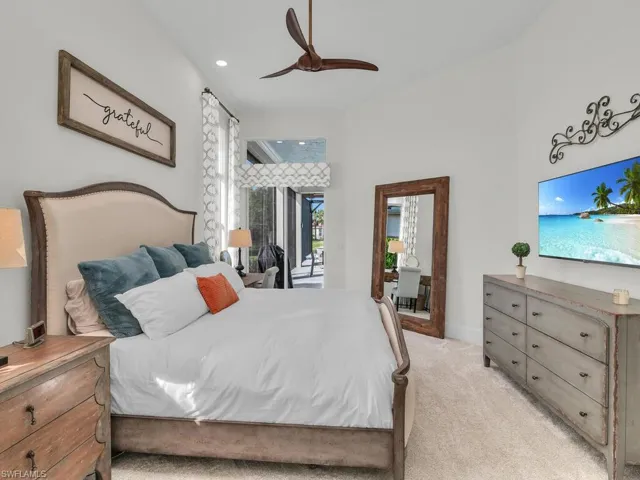 Primary bedroom with volume ceiling and sliders to lanai