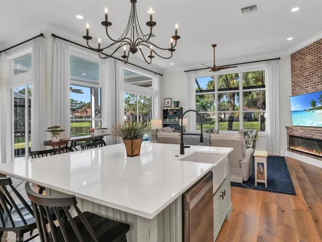 Kitchen featuring a huge center island with sink, chandelier, with loads of natural light and views