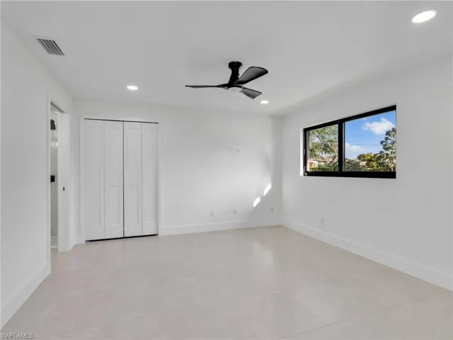Unfurnished bedroom with recessed lighting, ceiling fan, light tile patterned floors, and a closet