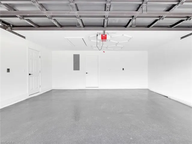 Garage with electric panel and a garage door opener