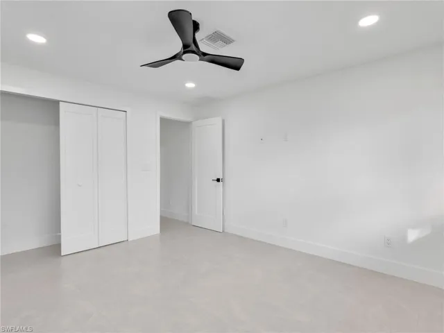 Unfurnished bedroom with recessed lighting, a closet, and a ceiling fan