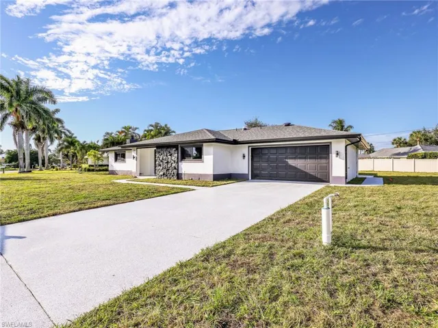 Ranch-style house with driveway, stucco siding, and an attached garage