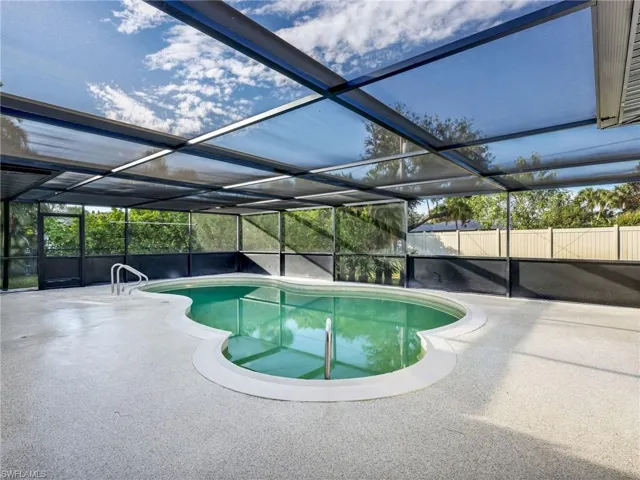 Swimming pool with a sunroom and a lanai