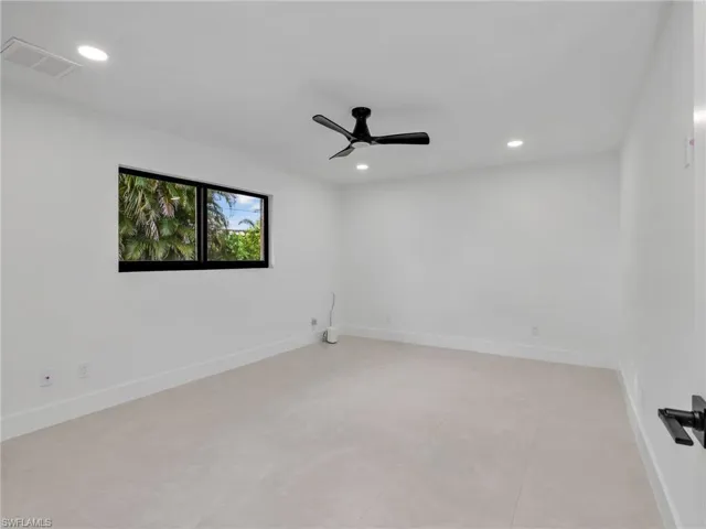 Spare room with recessed lighting and a ceiling fan