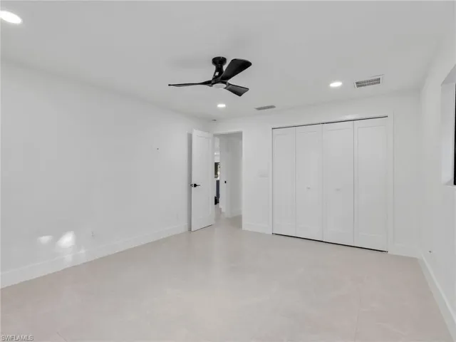 Unfurnished bedroom with recessed lighting, a ceiling fan, a closet, and light tile patterned flooring