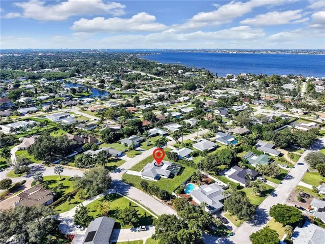 Aerial view of property's location with nearby suburban area