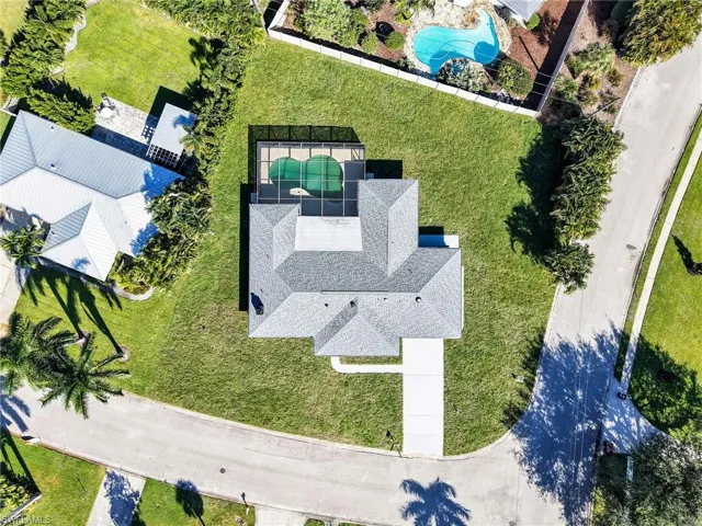 Aerial view of property and surrounding area featuring a pool area