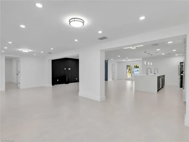 Unfurnished living room featuring recessed lighting and french doors