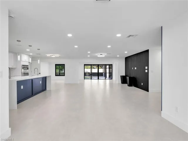 Unfurnished living room featuring recessed lighting