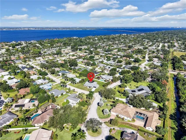Aerial view of property's location with nearby suburban area