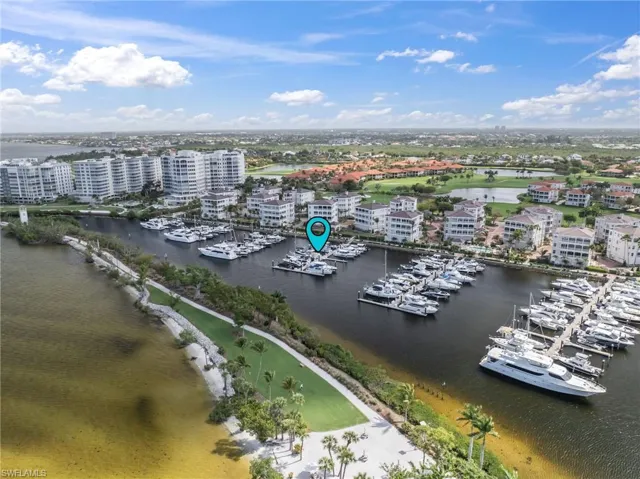 Drone / aerial view of a nearby body of water and numerous boat docks