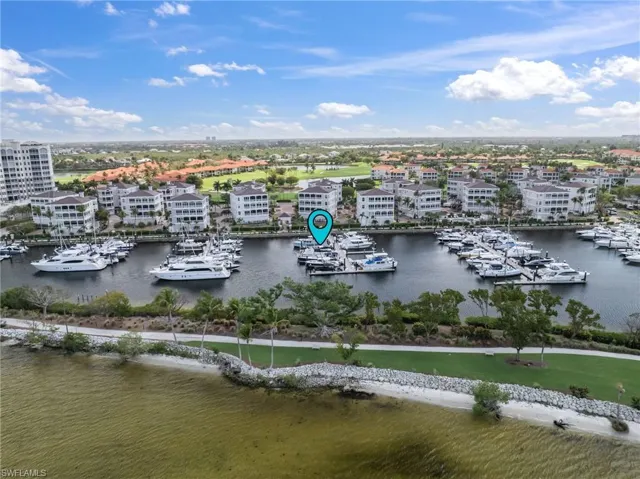 Aerial view of numerous boat docks and a large body of water