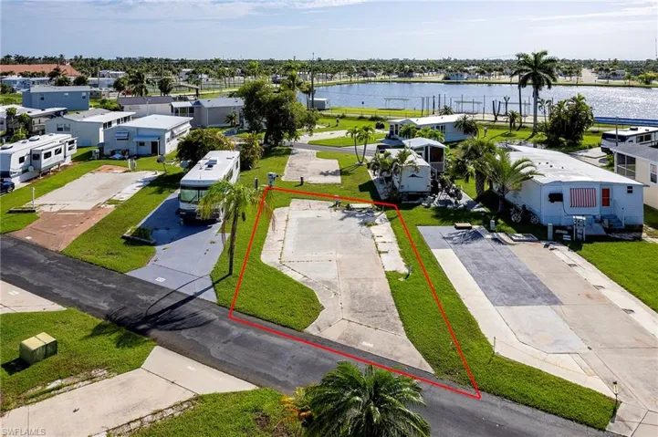 Birds eye view of property with a water view