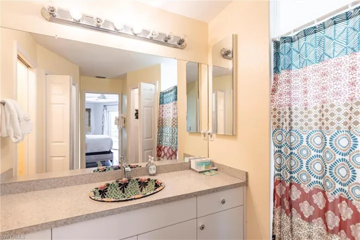 Bathroom with vanity, connected bathroom, and a shower with curtain