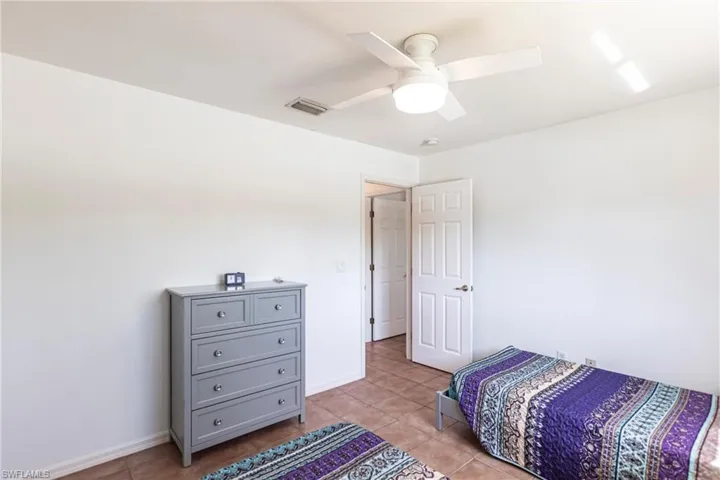 Bedroom featuring light tile patterned floors and ceiling fan