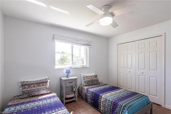 Tiled bedroom featuring a closet and a ceiling fan