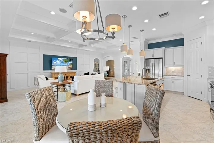 LARGE BREAKFAST AREA PERFECT FOR RELAXING WITH FRIENDS OVER A CUP OF COFFEE OR PLAYING CARDS OR DOMINOS. NOTE HOW BRIGHT WITH ALL THE UPDATED LIGHTING. YES! THE AMAZING BREAKFAST TABLE & CHAIRS REMAIN!