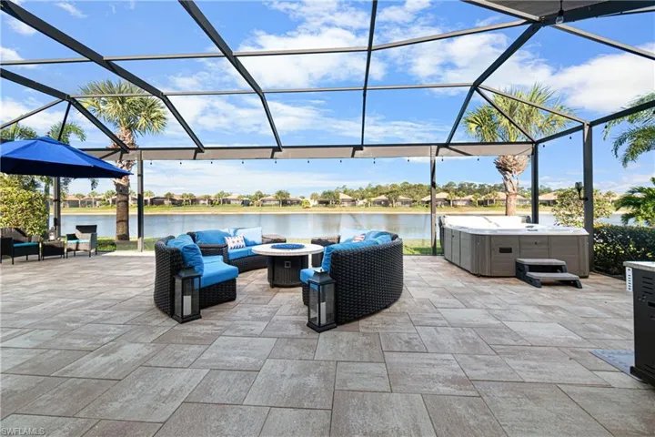 BEAUTIFUL LAKE VIEW WITH PICTURE WINDOW SCREEN & LARGE DECORATIVE TILES ON THE OVERSIZED LANAI. NOTE: THE HOT TUB REMAINS WITH THE HOME. SO BEAUTIFUL THAT THIS VIEW MUST BE SEEN IN PERSON TO TRULY APPRECIATE IT ESPECIALLY WHEN ENTERTAINING IN THE EVENINGS!