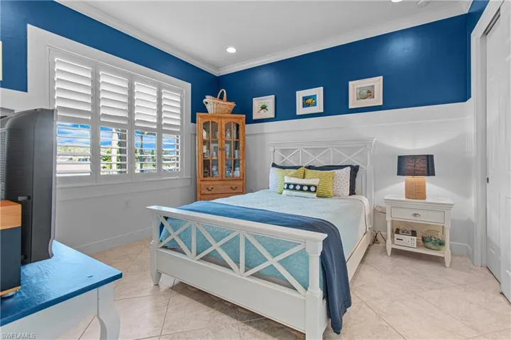 A 2ND AMAZING GUEST BEDROOM ALSO WITH 20” TILES ON The DIAGONAL=NO CARPET! PLUS PLANTATION SHUTTERS & PROFESSIONALLY PAINTED. SIMPLY BEAUTIFUL. BONUS: THE BED & NIGHTSTAND REMAIN WITH THE HOME!