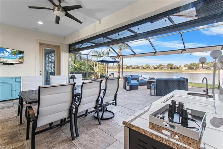 LAKE VIEW, ELECTRIC STORM SMART SCREENS, OUTDOOR COOKING STATION, HUGE PICTURE WINDOW FOR YOUR ENJOYMENT & LARGE DECORATIVE TILE FLOORING! LOOKS LIKE A PICTURE OUT OF A MAGAZINE BUT IT IS REAL & COULD SOON BE YOURS! BONUS:THE BEAUTIFUL OUTDOOR TABLE & 4 CHAIRS REMAIN!