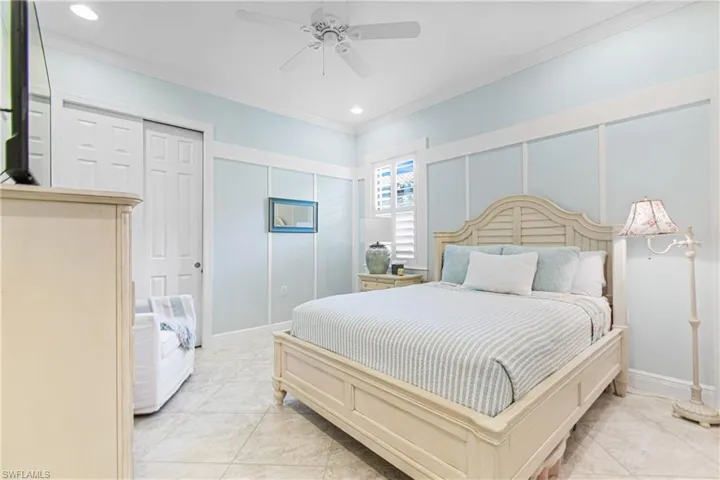 FLORIDIAN THEMED GUEST BEDROOM WITH TILED FLOORING=NO CARPET PLUS CUSTOM WOODWORK ON THE WALLS & 10 FT. CEILINGS & CUSTOM 8 FT. DOORS!