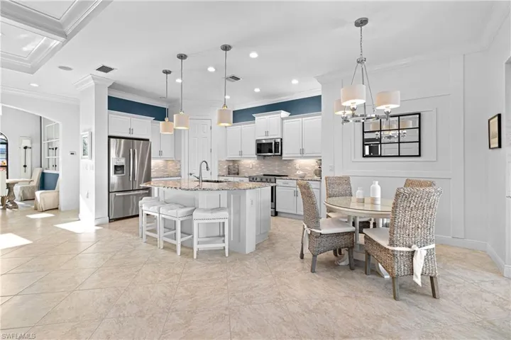 GREAT VIEW OF JUST HOW OPEN THE KITCHEN AREA IS. PLUS THE BARSTOOLS & ELEGANT BREAKFAST TABLE & CHAIRS REMAINS WITH THE HOME=GREAT VALUE FOR YOU.