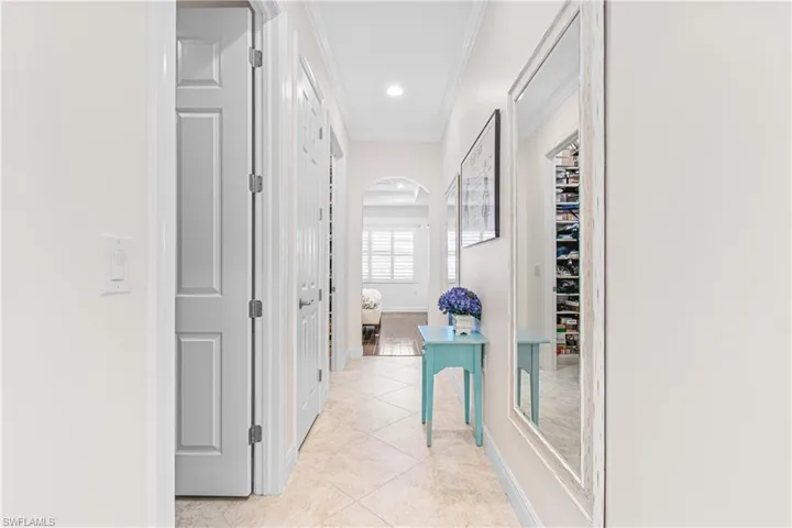 MASTER HALLWAY FROM SUITE TO BATH CONTAINING 2 LARGE CALIFORNIA THEMED HIS & HER CLOSETS! PLUS DOUBLE 8 FT. 6 PANEL PRIVACY DOORS LEADING INTO THE MASTER EN-SUITE. THE MASTER SUITE IS GIGANTIC & RUNS THE LENGTH OF THAT SIDE OF THE HOME!