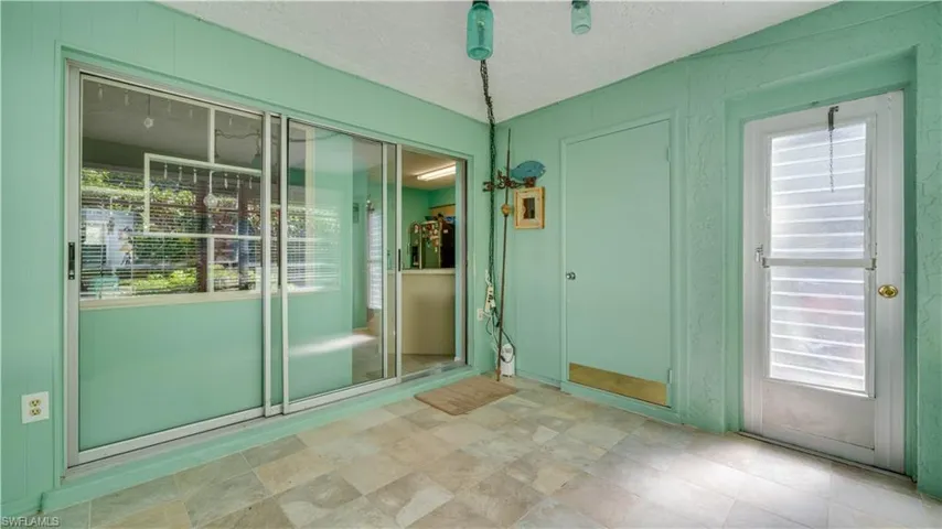 Doorway to outside with plenty of natural light and a textured ceiling