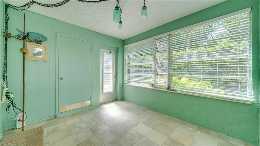 Empty room featuring a textured ceiling and a textured wall