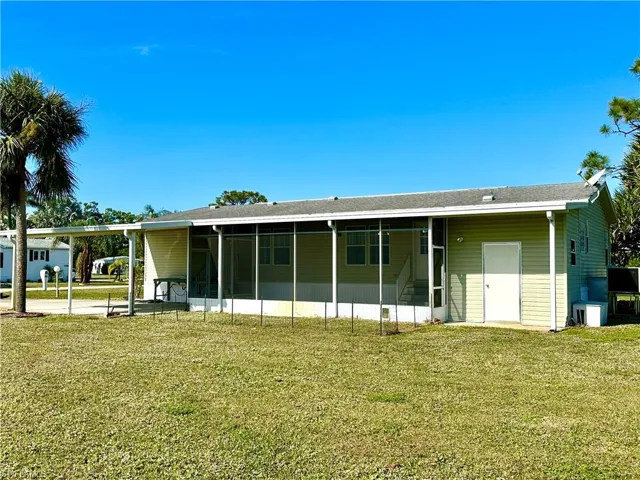 View of front of house featuring a front yard and a carport
