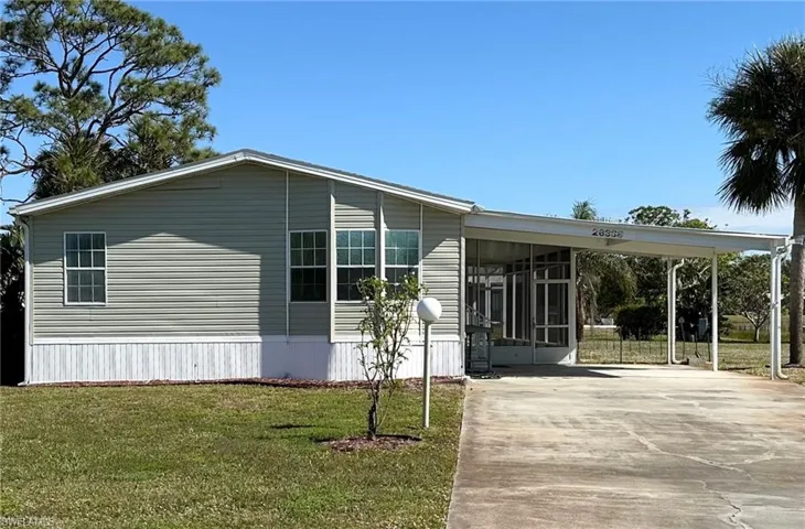 Front view of home, showing the carport.