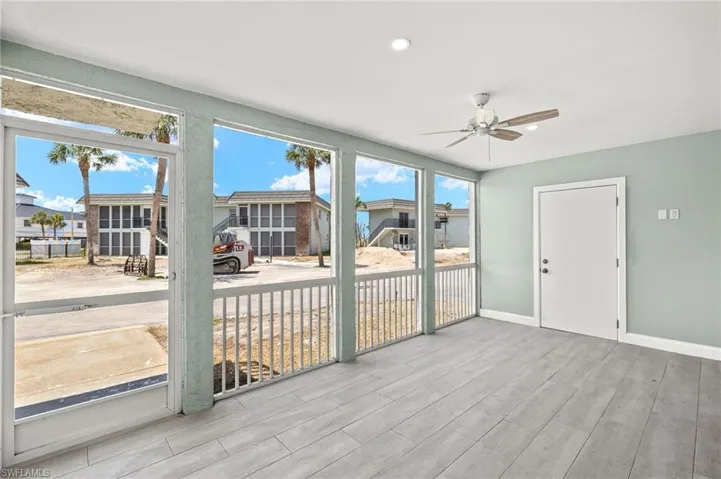 Screened lanai, featuring a ceiling fan, ceramic plank flooring and healthy amount of natural light