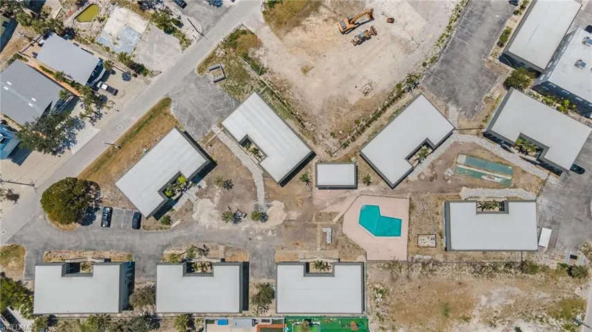 Aerial view of condo complex with community swimming pool
