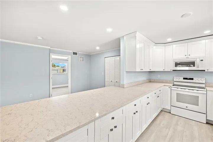 Quartz kitchen counters, white wood cabinetry