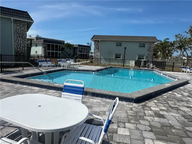 Current Community pool with a patio and outdoor dining area
